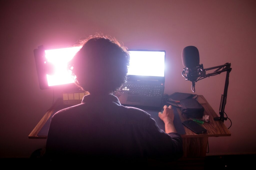 video editor sitting in front of a computer